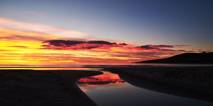 Photo of sunrise at Long Beach, Dunedin, New Zealand